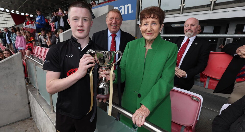 Virginia captain, Alex Maguire being presented the Billy Latimer Cup by Billy's wife, Betty.