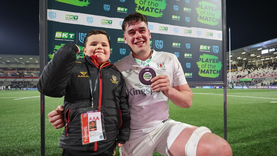 James McNabney receives his player of the match medal from Lurgan RFC's Ollie Smyth.